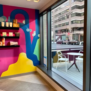 a brightly colored room with a table and chairs