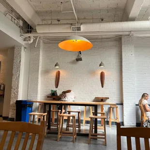 a woman sitting at a table in a restaurant