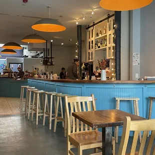 a view of a restaurant with tables and chairs