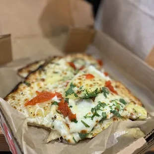 a slice of pizza in a box