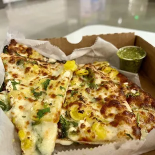 two slices of pizza in a box