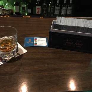 a glass of whiskey and playing cards