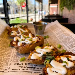 three baked potatoes topped with sour cream