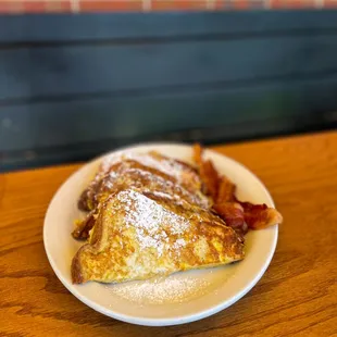 a plate of french toast and bacon