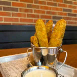 a tray of corn sticks and dipping sauce