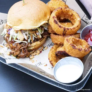 a pulled pork sandwich and onion rings