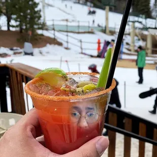 a person holding a bloody drink