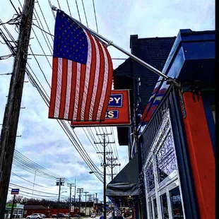 an american flag hanging from a pole