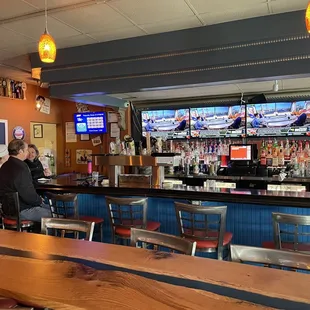 a man and a woman sitting at a bar
