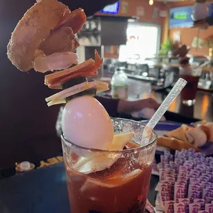 a cold drink with bacon and an egg on top