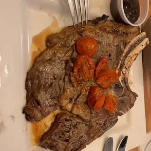 a large piece of steak on a white plate