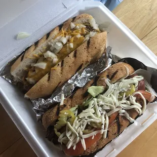 Chili dog (chili, cheese, and onions) and Roman dog (salami, lettuce, tomato, banana peppers, cheese, vinaigrette)