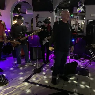 a band performing in a dimly lit room