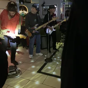a group of people playing guitars