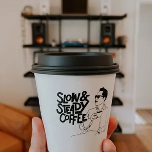 a person holding a coffee cup