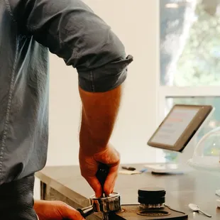 a man using a coffee grinder
