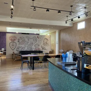 Interior of Slow Burn Coffee with art wall