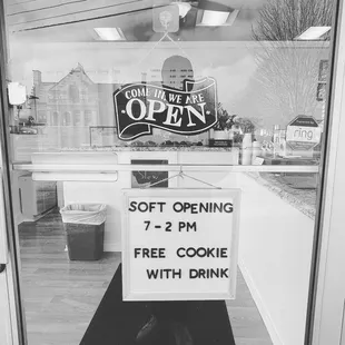 a sign in the window of a coffee shop