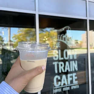 a hand holding a cup of coffee