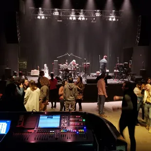a group of people standing in front of a stage