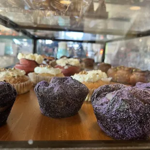 a variety of muffins in a display case