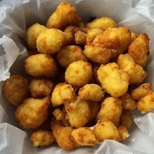 Cheese curds with a cornmeal like breading that retains too much grease and doesn&apos;t get crispy.