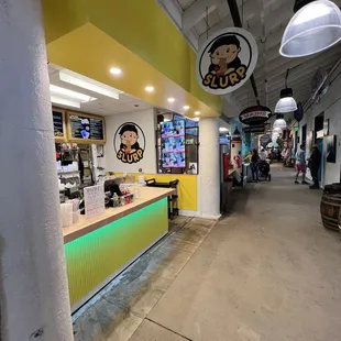 the inside of a restaurant with a neon green counter