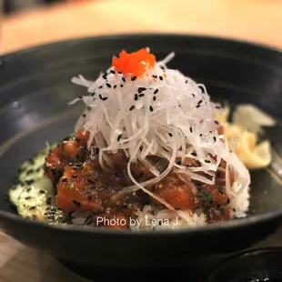Spicy Salmon Donburi ($20) - tartare-style salmon, daikon, cucumbers on sushi rice. Spicy sauce comes on the side.