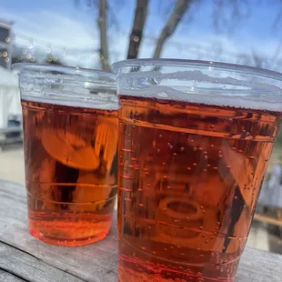 two glasses of cid on a picnic table