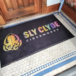 the logo on the door mat