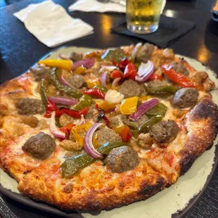 a pizza with sausage and peppers