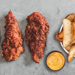 a plate of fried chicken and a bowl of fries