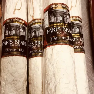 three rolls of bread wrapped in plastic wrap