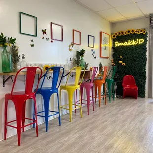 a row of colorful bar stools