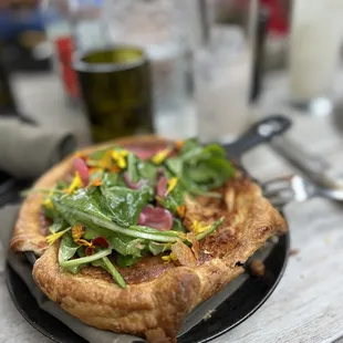 Quiche with mushrooms, purple cauliflower, gruyere. With greens and pickled onion on top.