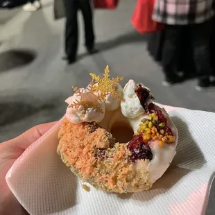 a hand holding a doughnut