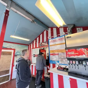 a man and a woman standing in front of a counter