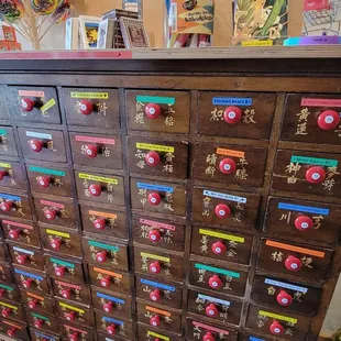 Multiple drawers full of various miniature items and regular-sized items