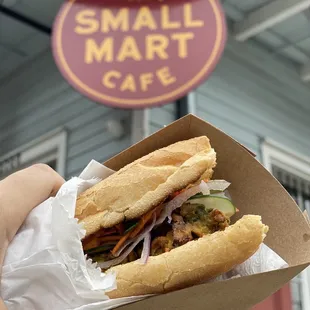 a person holding a sandwich in their hand