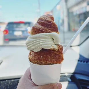 Pistachio soft serve in a croissant cone