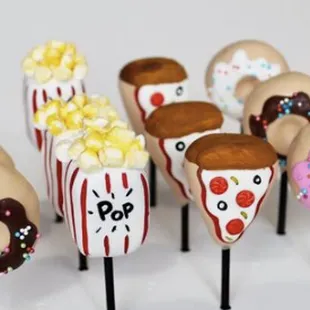 a variety of donuts on sticks