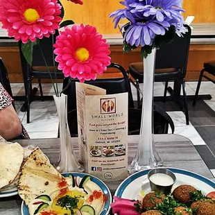 a woman sitting at a table with her plate of food