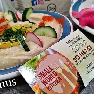 a plate of hummus and a plate of pita