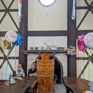 The inside showing most of the main table and the big chair for the birthday person on the inside of the party castle