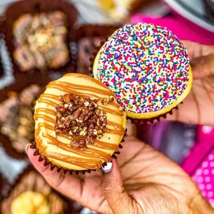 a person holding a donut with sprinkles