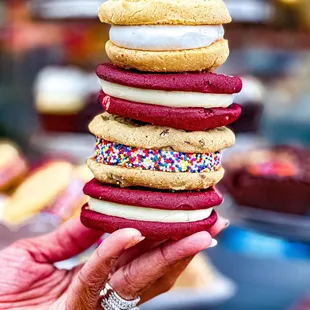 a hand holding a stack of cookies