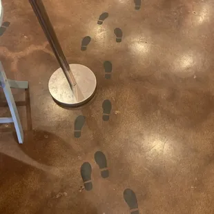 a person&apos;s foot prints on the floor