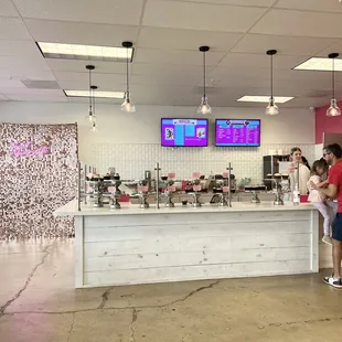 a woman and a child standing in front of a counter