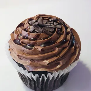 a cupcake with chocolate frosting