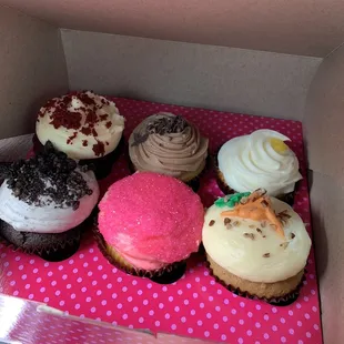 a variety of cupcakes in a box